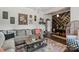 Open living room featuring hardwood floors, neutral paint, and a comfortable gray sectional sofa at 303 N Main N St, Granite Quarry, NC 28146