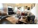 Inviting living room showcasing a comfortable gray sectional sofa, stylish decor, and plenty of natural light at 303 N Main N St, Granite Quarry, NC 28146
