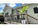 Charming side entrance with wooden porch featuring a natural wood railing, outdoor lights and plantings at 303 N Main N St, Granite Quarry, NC 28146