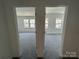 Hallway view of two bright bedrooms with neutral carpet and walls at 3117 Beacon Heights Rd, Indian Land, SC 29707