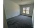 Neutral-toned bedroom with natural light, carpet, and view of the street at 3117 Beacon Heights Rd, Indian Land, SC 29707