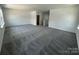Bright, open living room with neutral carpet and walls, offering a spacious and airy atmosphere at 3117 Beacon Heights Rd, Indian Land, SC 29707