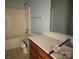 Bathroom features a shower-tub combo, white tiled flooring, a wood vanity, and light blue walls at 3240 St Vincent Dr, Claremont, NC 28610