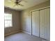 Neutral bedroom with closet, window, ceiling fan and carpeted floors at 3240 St Vincent Dr, Claremont, NC 28610