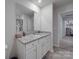 Bathroom featuring a large mirror over a granite-topped vanity, with an adjacent open doorway at 3322 Brighton Dr, Gastonia, NC 28052