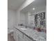Bright bathroom featuring a modern vanity with granite countertop and a shower with decorative shower curtain at 3322 Brighton Dr, Gastonia, NC 28052