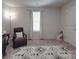 This spacious bedroom features neutral walls and carpet, a rocking chair, and a large window at 3322 Brighton Dr, Gastonia, NC 28052