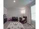 Inviting bedroom with a rocking chair, play area, and neutral tones creating a serene and versatile space at 3322 Brighton Dr, Gastonia, NC 28052