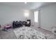 Cozy bedroom features neutral walls and carpet, a rocking chair, and a play area with ample natural light at 3322 Brighton Dr, Gastonia, NC 28052