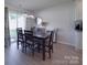 A well lit dining area with stylish light fixture and seating for six at 3322 Brighton Dr, Gastonia, NC 28052