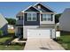 Charming two-story home featuring a two car garage, and manicured landscaping at 3322 Brighton Dr, Gastonia, NC 28052
