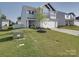 Landscaped front yard featuring mature trees, green grass, and a charming two-story home at 3322 Brighton Dr, Gastonia, NC 28052