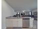 Stainless dishwasher, granite countertop and white cabinets in this kitchen at 3322 Brighton Dr, Gastonia, NC 28052