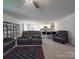 Spacious living room with ceiling fan, plush carpet, and open floor plan to the kitchen at 3322 Brighton Dr, Gastonia, NC 28052