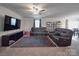 Spacious living room features a ceiling fan, large tv, decorative rug, and comfortable seating at 3322 Brighton Dr, Gastonia, NC 28052