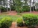 A lush backyard with mature trees and manicured landscaping, creating a serene outdoor environment at 3602 Melrose Cottage Dr, Matthews, NC 28105