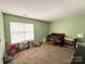 Tranquil bedroom featuring soft green walls, a crib, toys and plenty of natural light at 3602 Melrose Cottage Dr, Matthews, NC 28105