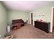 Inviting bedroom with light green walls, a crib, dresser, and carpeted floors at 3602 Melrose Cottage Dr, Matthews, NC 28105