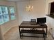 Bright dining area illuminated by a chandelier, with tile flooring and a workspace setup at 3602 Melrose Cottage Dr, Matthews, NC 28105