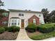 Inviting townhouse showcasing manicured landscaping, siding, brick accents, and a pathway to the front door at 3602 Melrose Cottage Dr, Matthews, NC 28105