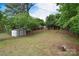 Lush backyard with a convenient storage shed and mature trees at 3623 Braden Dr, Charlotte, NC 28216