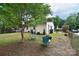 Spacious backyard featuring lush greenery and a charming patio setup at 3623 Braden Dr, Charlotte, NC 28216