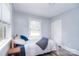 A comfortably furnished bedroom features wood-look flooring and natural lighting from windows at 3623 Braden Dr, Charlotte, NC 28216