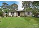 Well-maintained home with a lush green lawn and mature trees at 3623 Braden Dr, Charlotte, NC 28216
