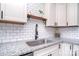 Bright kitchen features white subway tile backsplash, granite countertops, and stainless steel sink at 3623 Braden Dr, Charlotte, NC 28216