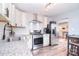 Updated kitchen features stainless appliances, subway tile, and white cabinetry at 3623 Braden Dr, Charlotte, NC 28216