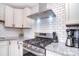 Close up of a kitchen featuring stainless steel range and range hood at 3623 Braden Dr, Charlotte, NC 28216