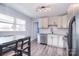 Updated kitchen with white cabinets and stainless steel appliances, plus dining area at 3623 Braden Dr, Charlotte, NC 28216