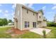 Tan home showcasing a concrete patio with sliding glass door entry and manicured lawn at 4004 Shasta Cir, Clover, SC 29710