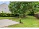 Lush backyard with mature trees, green grass, patio area, and wood fence at 4004 Shasta Cir, Clover, SC 29710