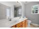 Inviting bathroom with double sink vanity, wood cabinets, and plenty of light from dual windows at 4004 Shasta Cir, Clover, SC 29710