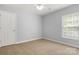 Cozy bedroom with plush carpet, neutral paint, standard closet, and a window providing soft natural light at 4004 Shasta Cir, Clover, SC 29710