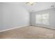 Spacious bedroom featuring plush carpeting, a ceiling fan, and a large window for natural light at 4004 Shasta Cir, Clover, SC 29710