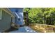 Backyard featuring a wood deck, concrete patio, and lush green foliage at 401 Pamela St, Gastonia, NC 28054