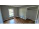 Bedroom featuring hardwood floors, closet, and window offering natural light and outdoor views at 401 Pamela St, Gastonia, NC 28054