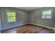 Bedroom with two windows featuring hardwood floors at 401 Pamela St, Gastonia, NC 28054