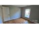 Bright bedroom featuring gleaming hardwood floors and a sun-filled window at 401 Pamela St, Gastonia, NC 28054