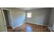 Neutral bedroom featuring hardwood floors and a window at 401 Pamela St, Gastonia, NC 28054