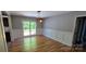 Open dining area featuring hardwood floors, wainscoting, sliding glass doors leading to outdoor deck at 401 Pamela St, Gastonia, NC 28054