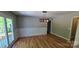 Bright dining room featuring hardwood floors, modern light fixture, and access to an outdoor deck at 401 Pamela St, Gastonia, NC 28054