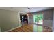 Light-filled dining area with hardwood floors, decorative light fixture and access to the kitchen at 401 Pamela St, Gastonia, NC 28054