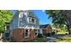 Charming two-story home with a brick facade and gray siding, featuring a well-maintained front yard at 401 Pamela St, Gastonia, NC 28054