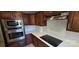 Bright kitchen features stainless steel appliances, quartz countertops, and dark cabinets at 401 Pamela St, Gastonia, NC 28054