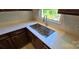 Stainless steel kitchen sink with modern fixtures, situated beneath a bright window offering outdoor views at 401 Pamela St, Gastonia, NC 28054