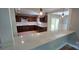 Lovely kitchen with dark cabinets and quartz countertops, leading to a dining area with outside access at 401 Pamela St, Gastonia, NC 28054