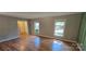 Sun-filled living room with hardwood floors and two large windows allowing for ample natural light at 401 Pamela St, Gastonia, NC 28054